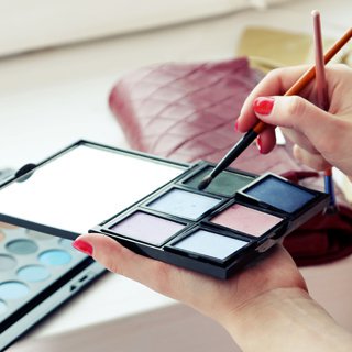 close-up of makeup artist at work  with cosmetics